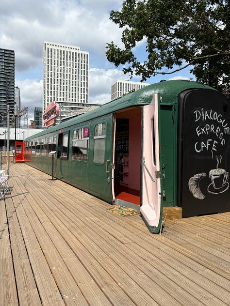 Different perspectives of the cafe inside an old railway carriage. There is a big wooden terrace.