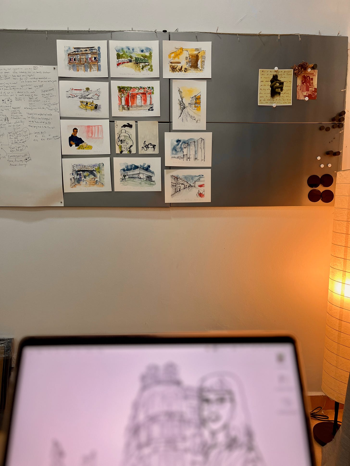 Image: photo of the metal board with writings on the big piece of paper. And numerous ink and watercolour paintings of Portugal’s landscape, and a few paintings sketched live from surroundings.