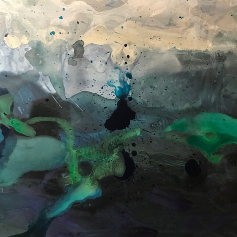 Some paintings as works in progress, with swirls of blue, green and silver.