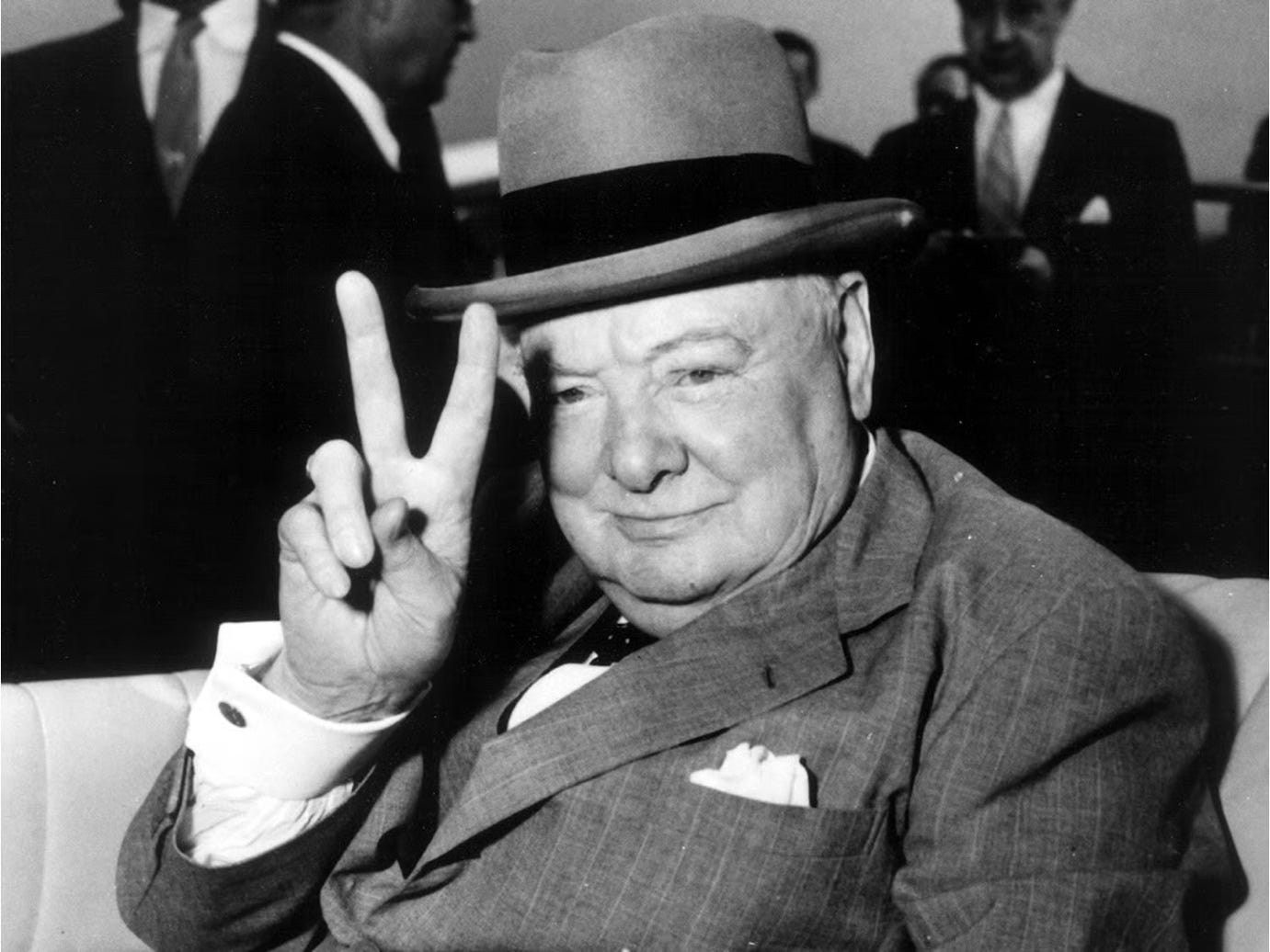 A person in a suit and hat
AI-generated content may be incorrect.