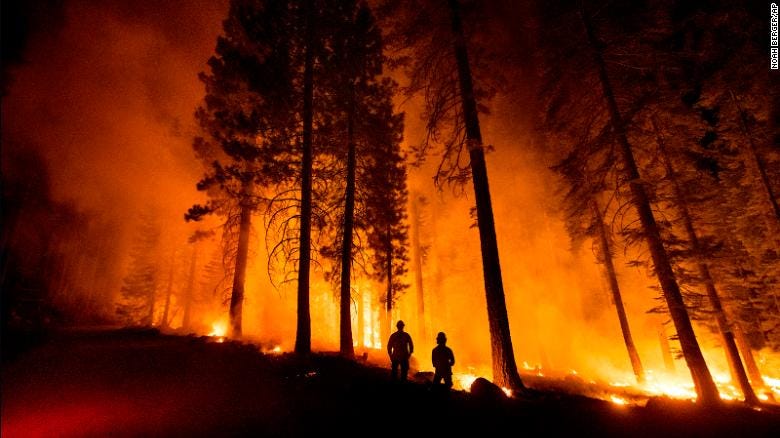 Cal Fire Capts. Tristan Gale, left, and Derek Leong monitor a firing operation in California&#39;s Lassen National Forest on July 26. Crews had set a ground fire to stop the Dixie Fire from spreading.