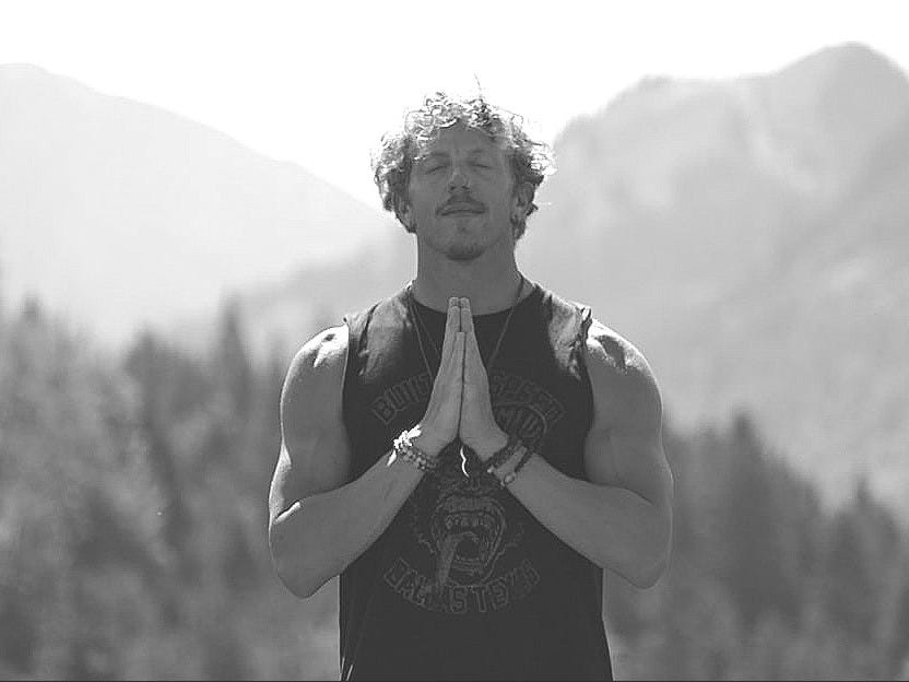 woman in black tank top standing on green grass field during daytime