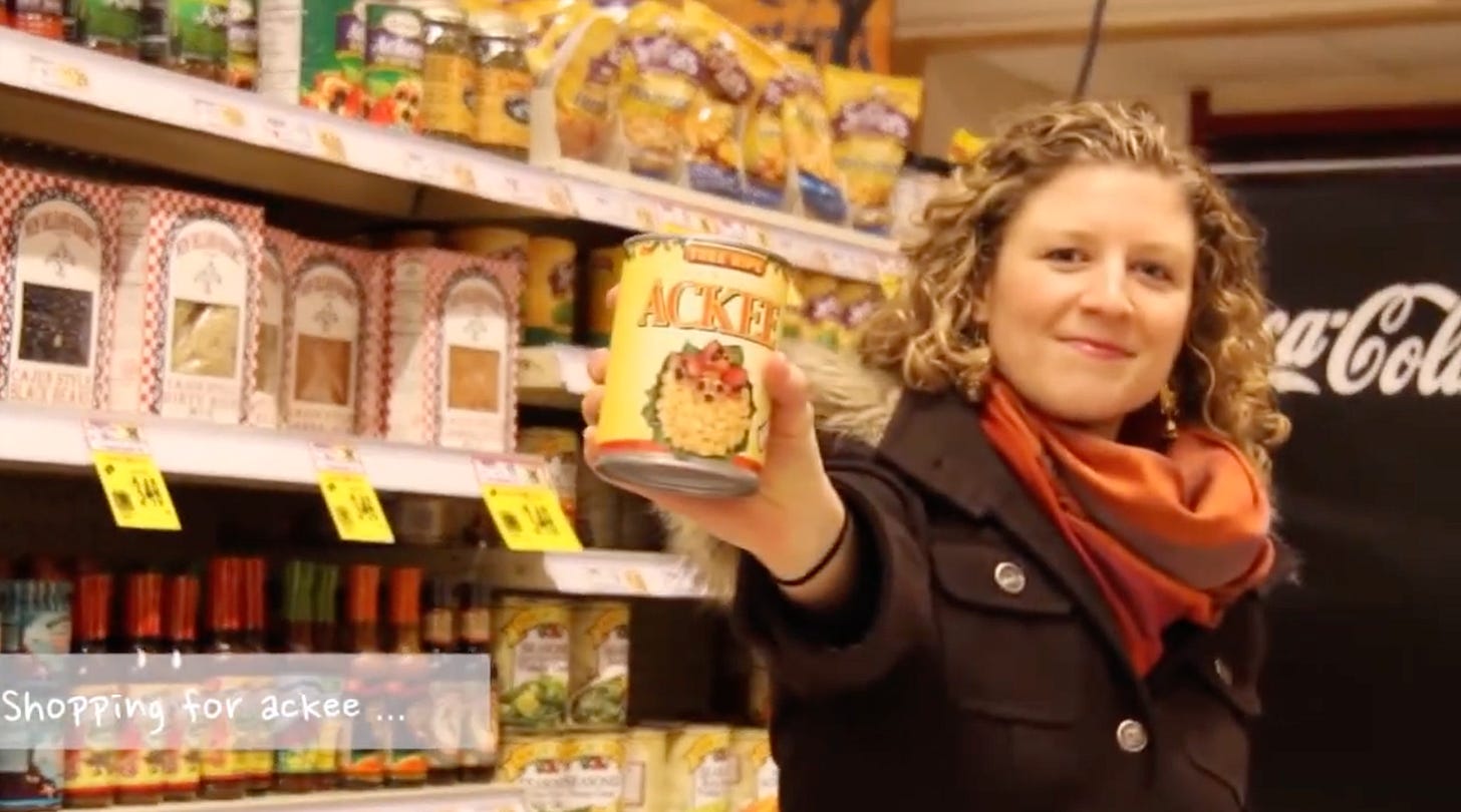 Woman in a grocery store aisle holding out a can of Ackee