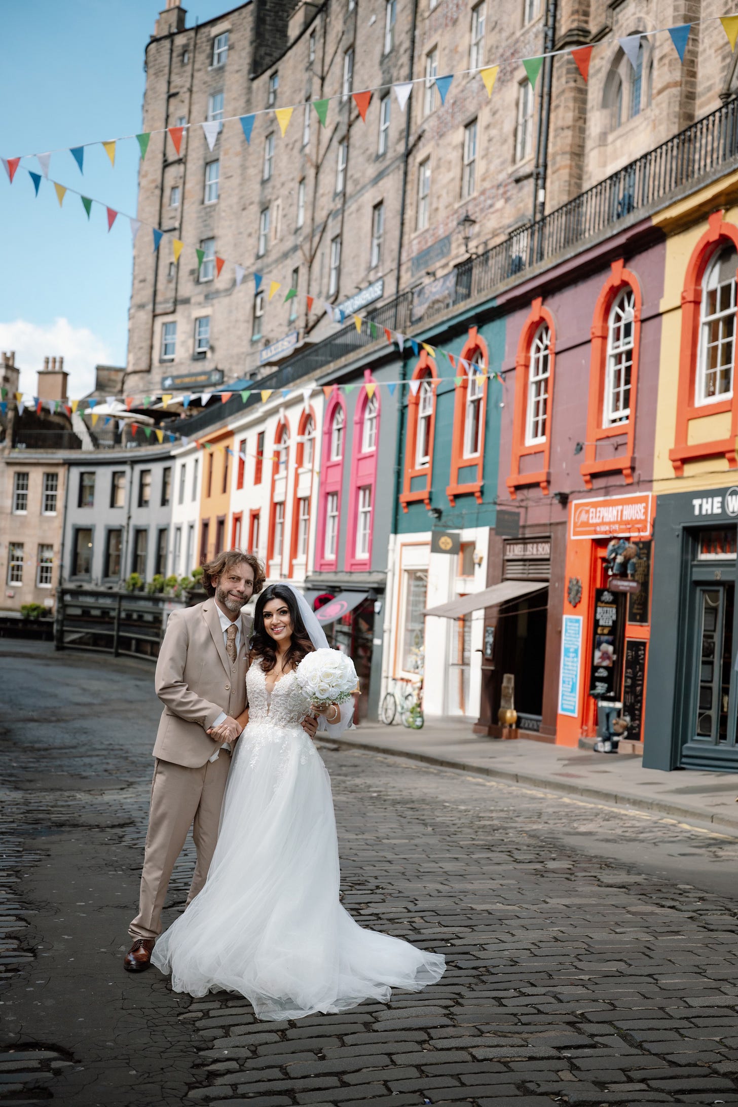 Adam Juniper and Ariane Sherine Juniper on their wedding day in the middle of Edinburgh's colourful George Street