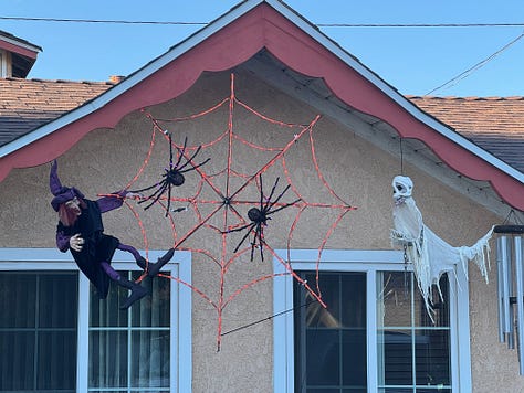 Various Halloween displays--including witches, skeletons, spiders, and a talking medieval knight--in front yards along Santa Paula Street.