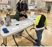 MCS student visiting a table run by a Dartmouth College student MCS student visiting a table run by a Dartmouth College student