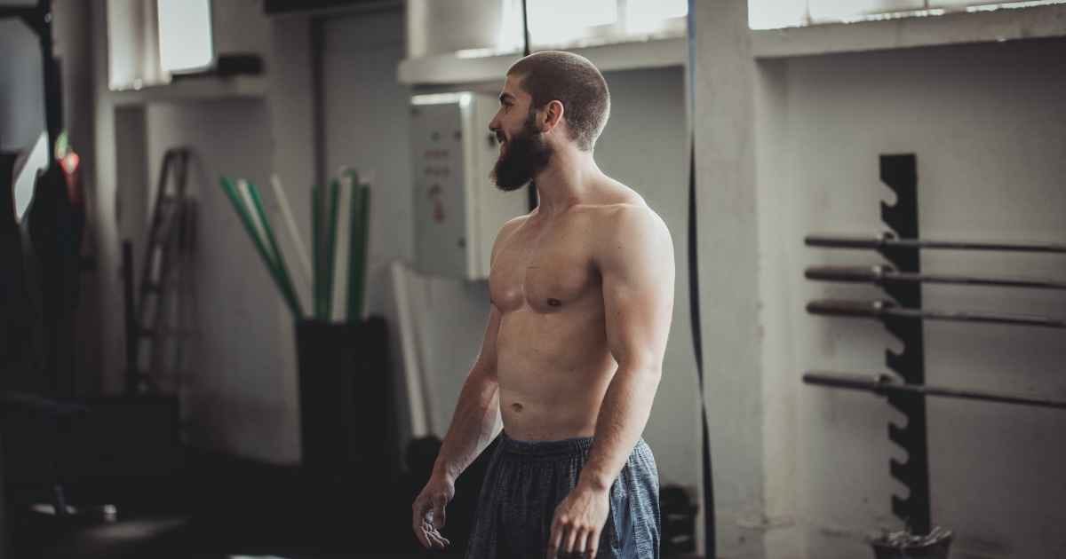 Young man standing in the gym alone