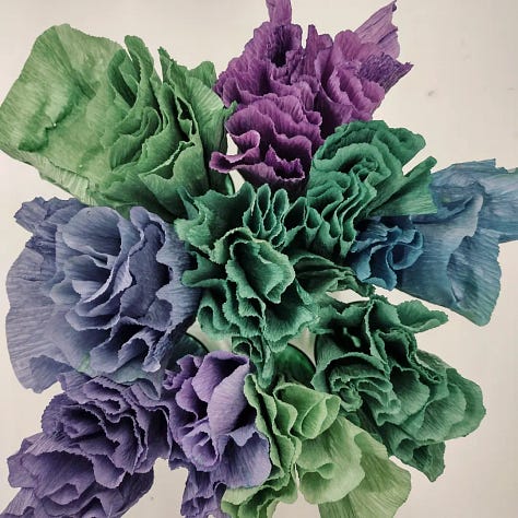 Pictures of red cabbage and papers dyed using red cabbage in December 2022. Bright jewel tones of green, turquoise, blues, lilacs and purples.