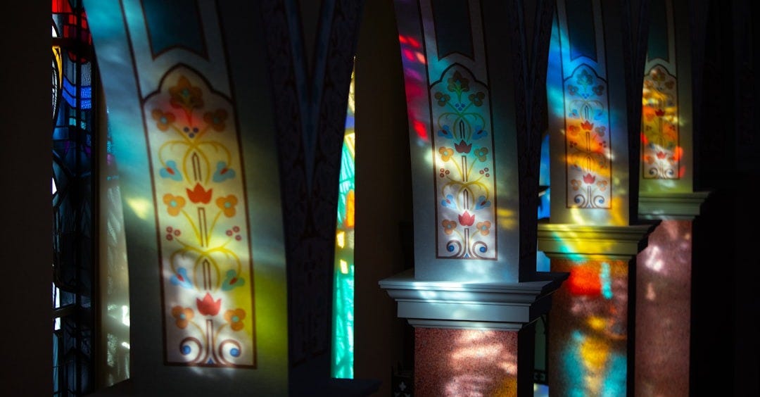 a row of stained glass windows in a church a row of stained glass windows in a church
