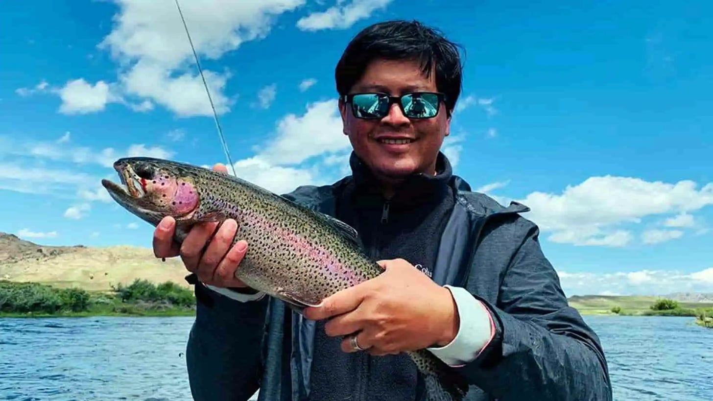 Angler Crouched with Bright Rainbow