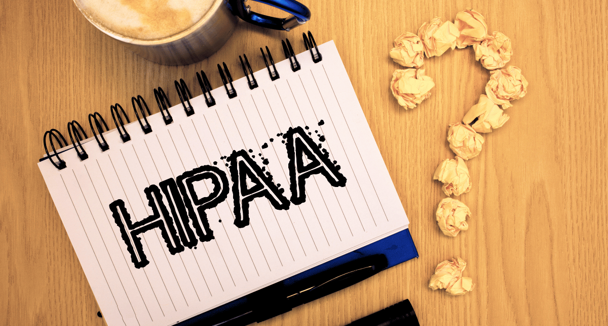 Notebook with HIPAA written on the page, a question mark next to it Notebook with HIPAA written on the page, a question mark next to it