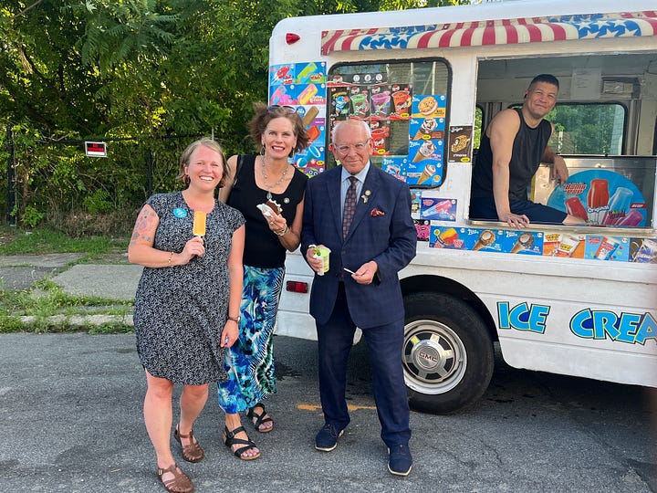 Selfie of Christine in front of the new Habitat houses; photo of Christine with state senator, U.S. congressman and an ice cream truck on Orange St.