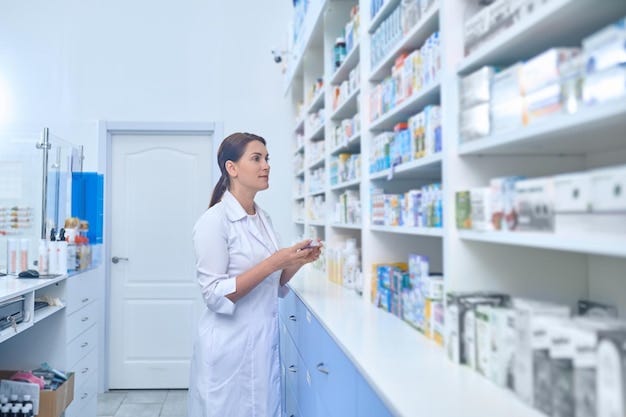 Female pharmacist working in a drugstore Female pharmacist working in a drugstore