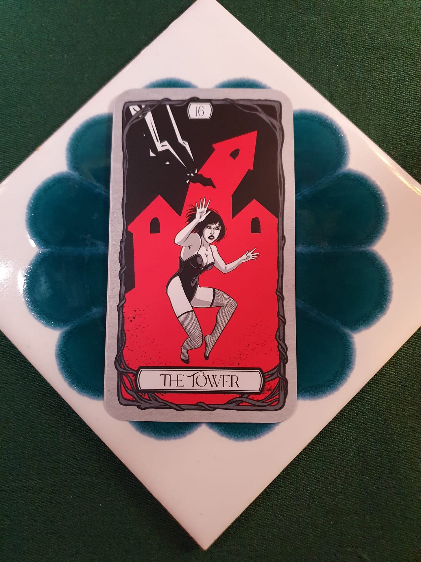 The Tower tarot card selected for Elizabeth Sulis Kim’s Tarot DMs chat, with a red tower struck by lightning and a falling figure. The Tower tarot card selected for Elizabeth Sulis Kim’s Tarot DMs chat, with a red tower struck by lightning and a falling figure.