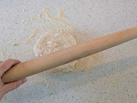 Rolling and fitting the dough. I once rolled dough with a very large carrot when I didn't have a rolling pin. Feel free to improvise