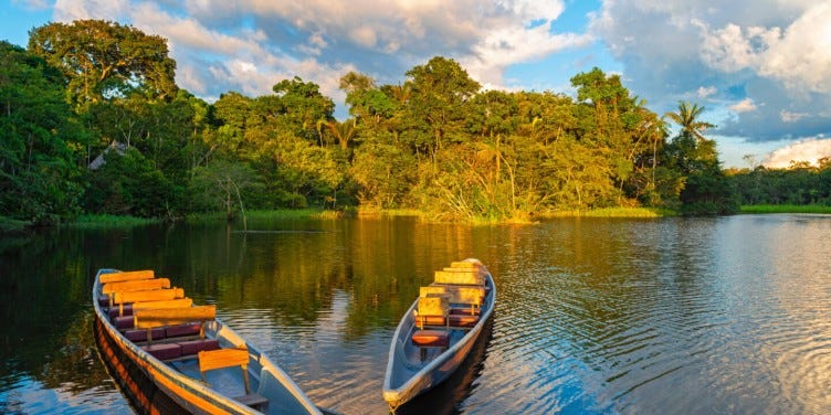 Two traditional wooden canoes at sunset in the Amazon River Basin with the tropical rainforest in the background, Yasuni National Park, Ecuador (image: Alamy)