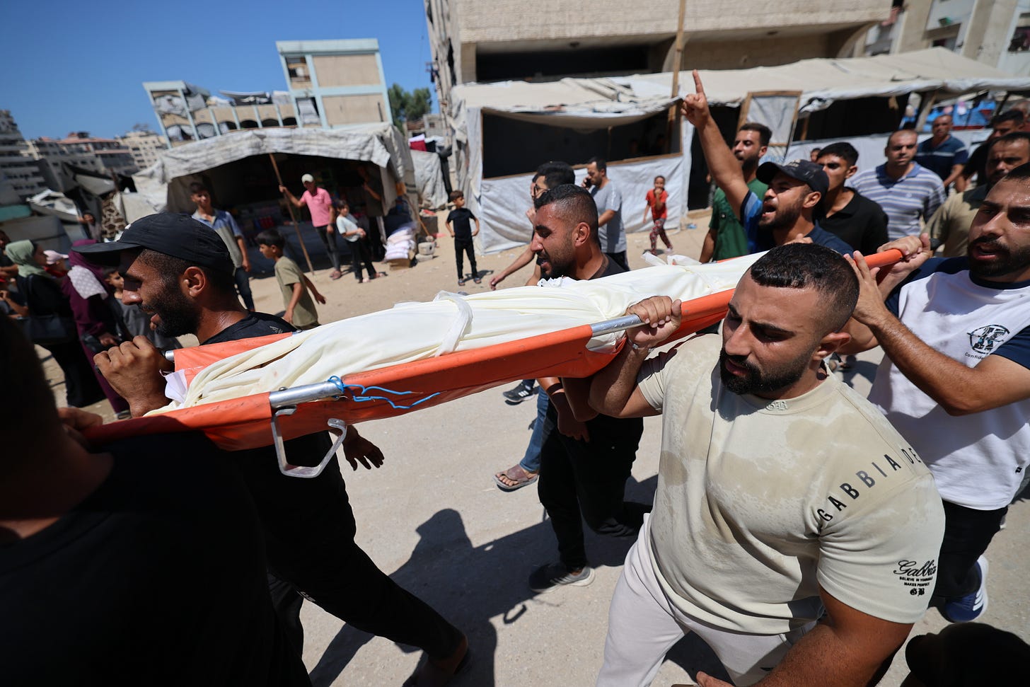 Mourners carry the body of a 13-year-old boy who was killed in an Israeli airstrike in Gaza City on Sept. 1, 2026, as he collected water. Photo by Omar Ashtawy/Getty Images