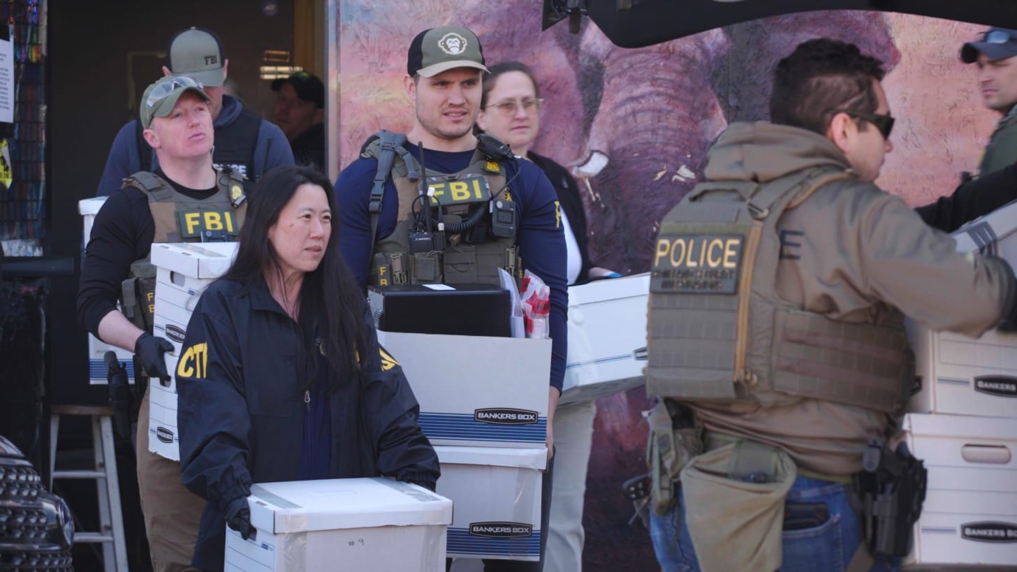 FBI agents and police officers carry boxes of seized records from a site during the Minnesota Medicaid fraud investigation. FBI agents and police officers carry boxes of seized records from a site during the Minnesota Medicaid fraud investigation.