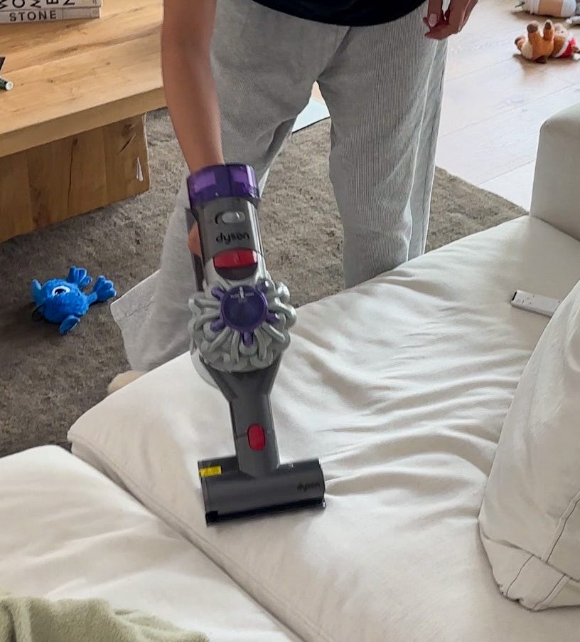Erin using a Dyson Handheld Vacuum.
