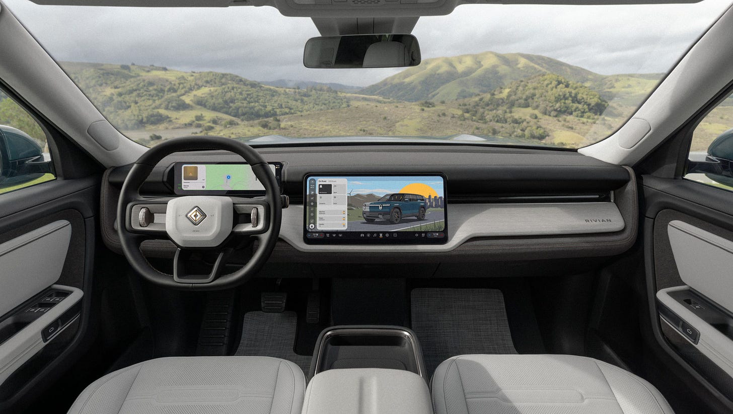 vehicle interior with steering wheel, digital instrument cluster, center touchscreen, light seats.