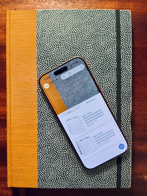 A photo of a diary with a phone on top containing a digital copy of the same diary.