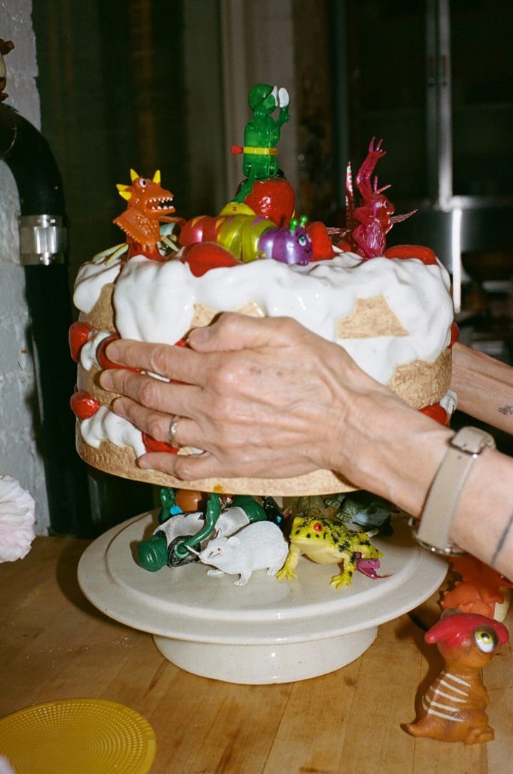 Close-up of a cake stand filled with vintage wind-up toys on a table