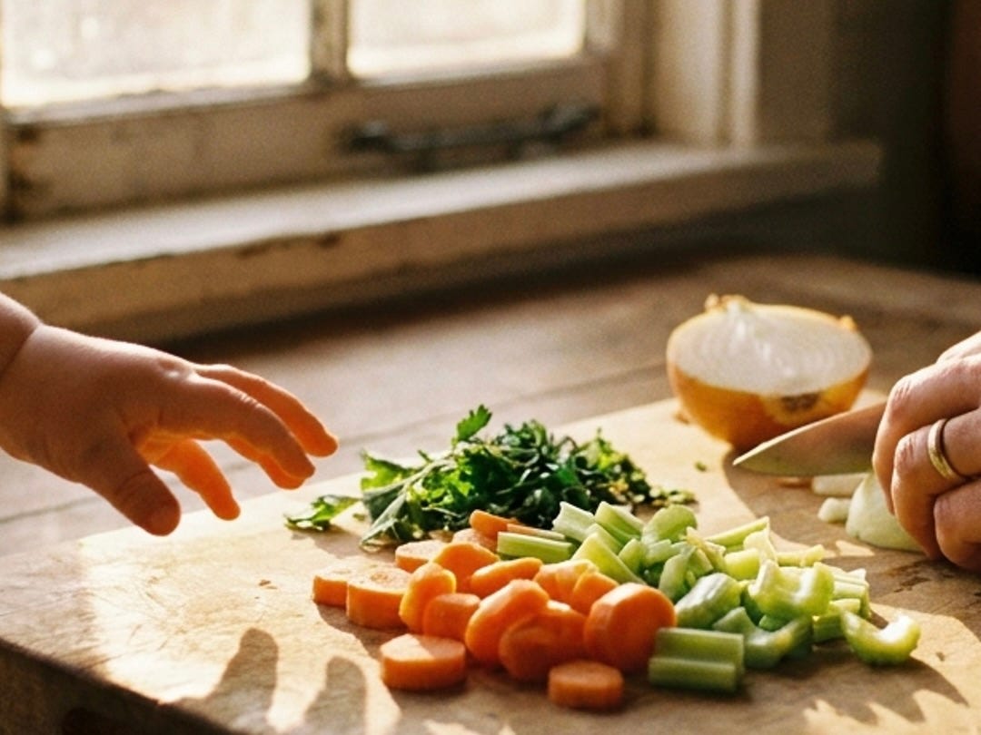 Small child's hand reaching toward cutting board as adult pauses mid-chop in warm kitchen light, care meeting presence Small child's hand reaching toward cutting board as adult pauses mid-chop in warm kitchen light, care meeting presence