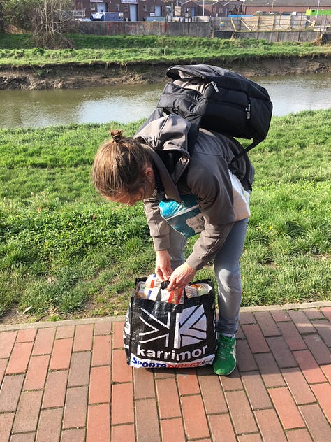 First photo shows a hand with silver rings on the fingers holding a mostly yellow espresso cup bearing the words "may you live in interesting times"; the second image is the author with long, lank straight hair; in the third image, the author is struggling with an over-filled bag of shopping on the footpath beside the river Ouse