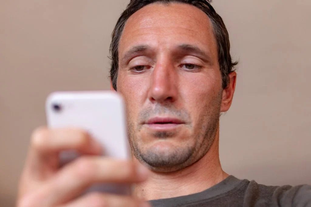 Looking at phone dumbly. Looking at phone dumbly.