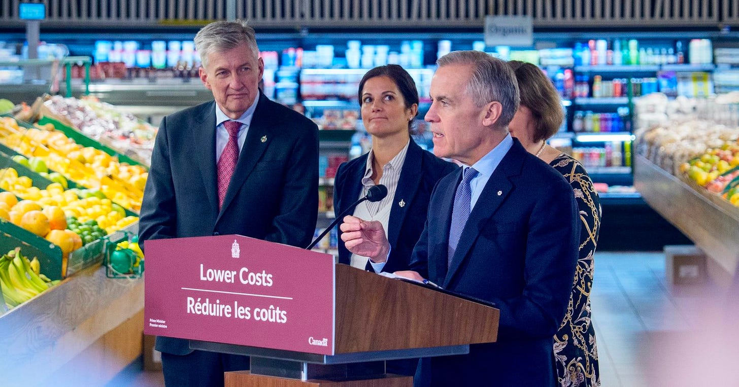 Prime Minister Carney at a podium in a grocery store in Ottawa, Ontario. Prime Minister Carney at a podium in a grocery store in Ottawa, Ontario.
