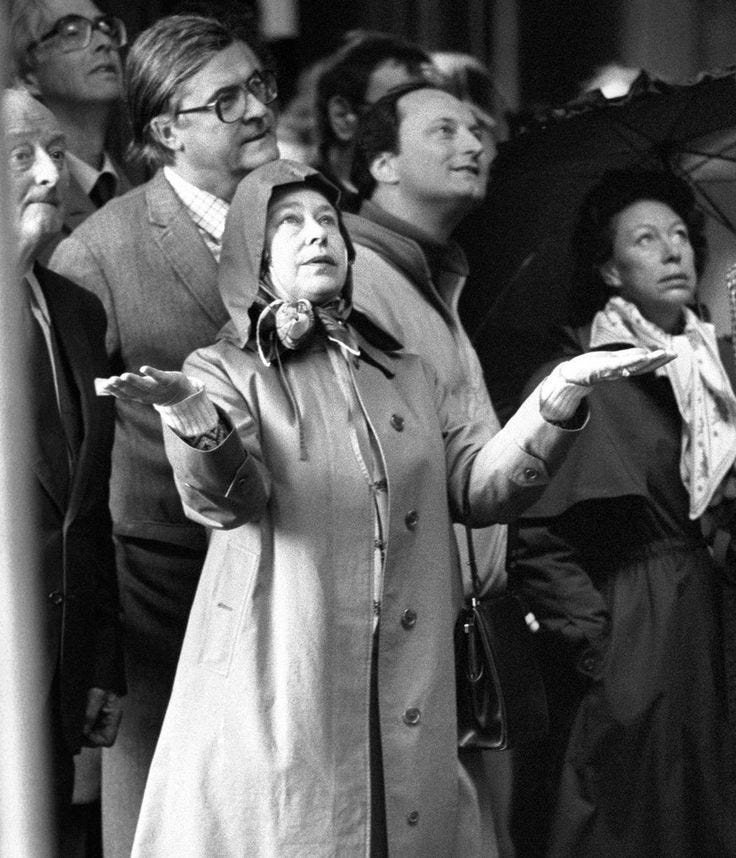 This may contain: a group of people standing around each other with umbrellas in their hands and looking up at the sky