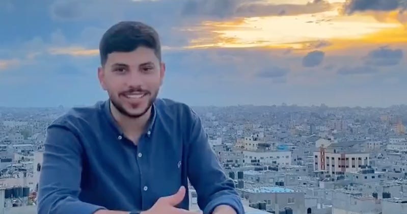 A person sitting on a balcony with a city in the background

Description automatically generated