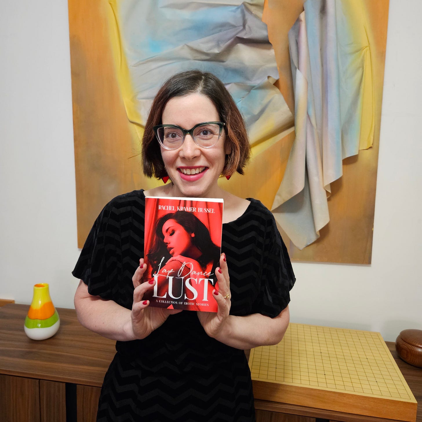 rachel kramer bussel holding her erotica book lap dance lust