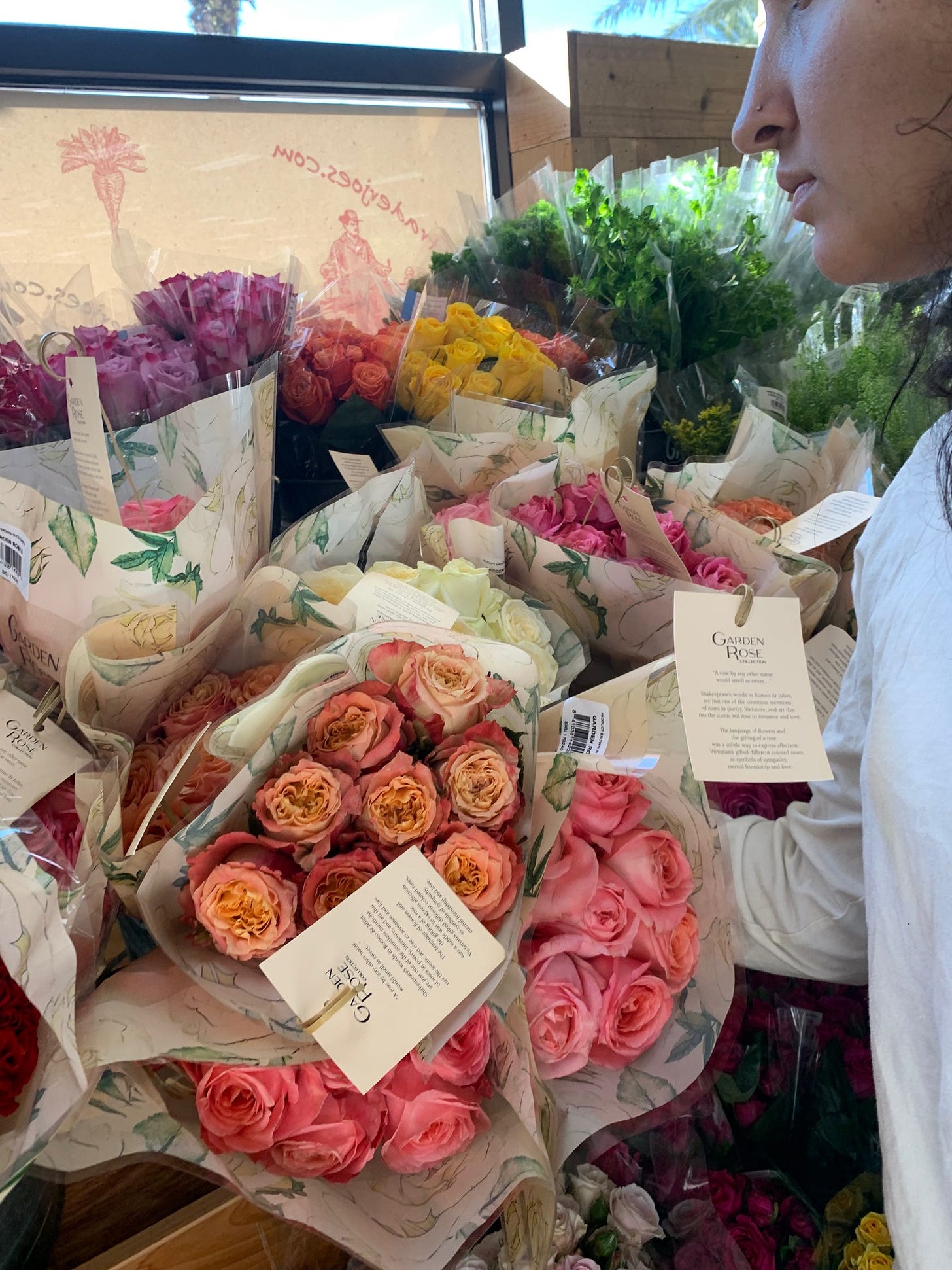 Kayla looks at roses in Trader Joes