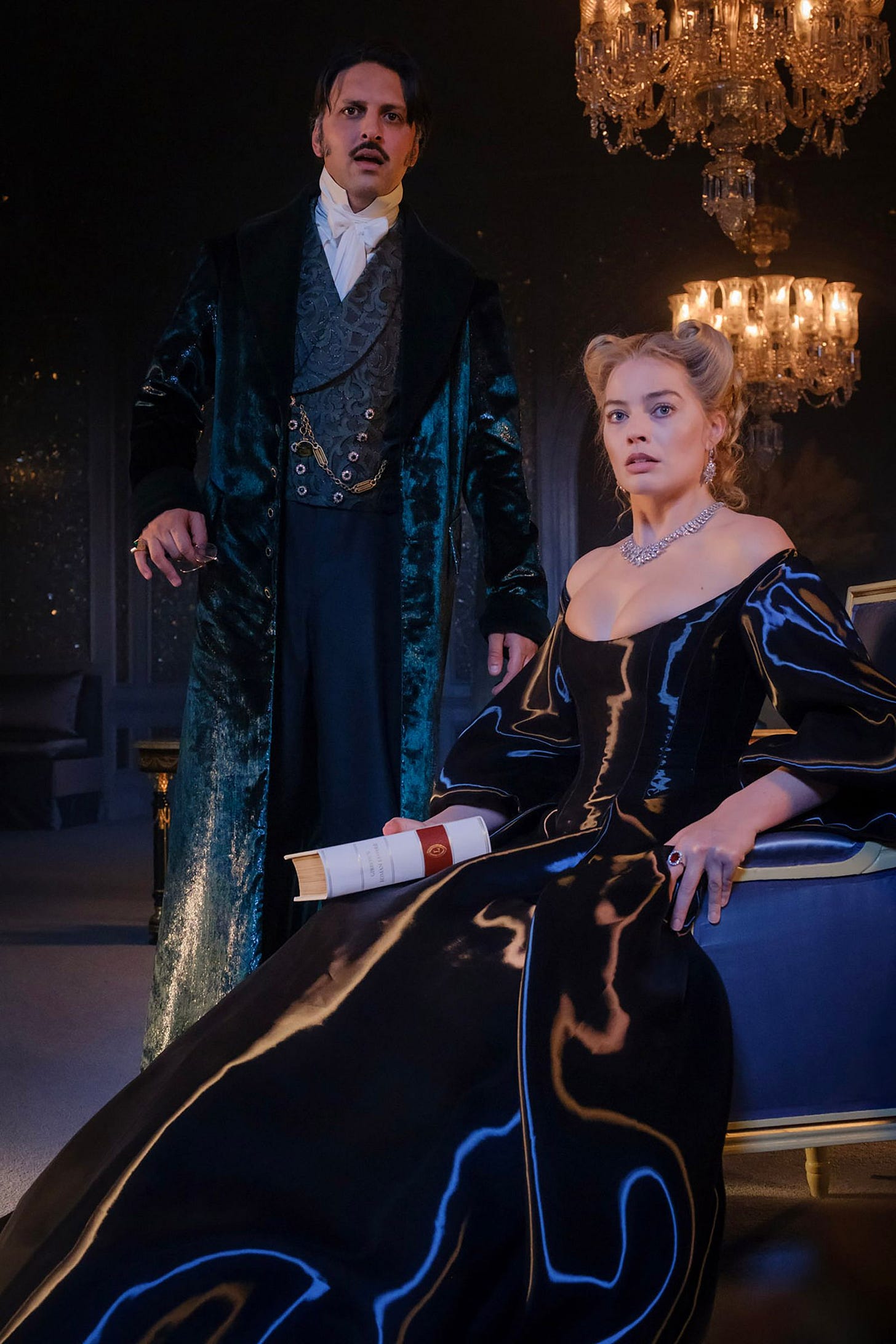 Image may contain Margot Robbie Shazad Latif Person Adult Clothing and Coat