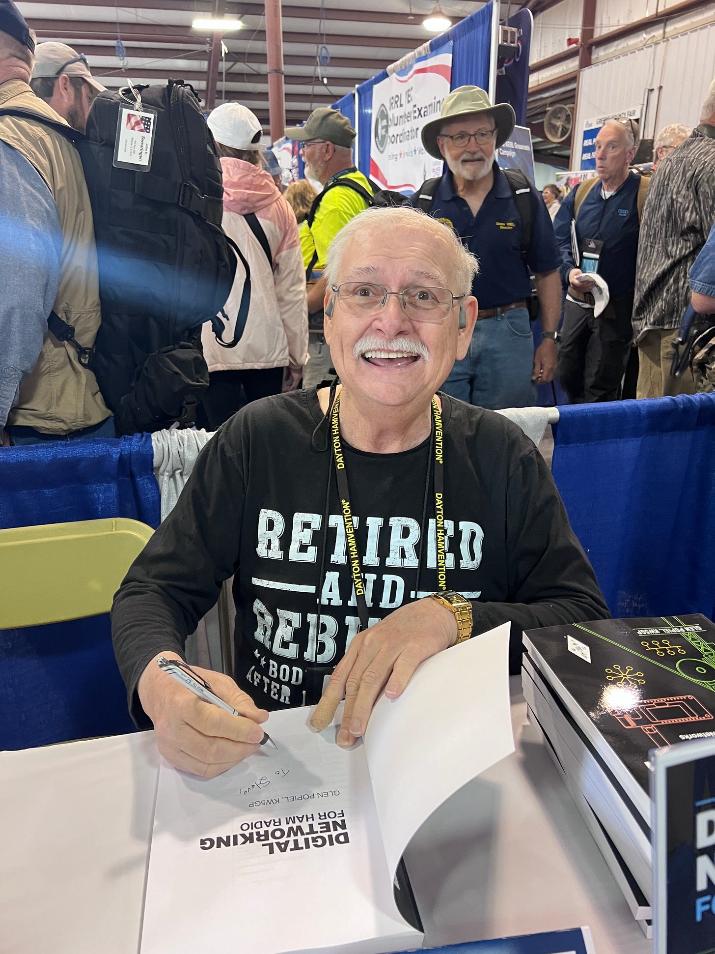 Glen Popiel KW5GP at Hamvention 2026 autographing my copy of his new book Digital Networking for Ham Radio book. Image courtesy of Steve Stroh N8GNJ.