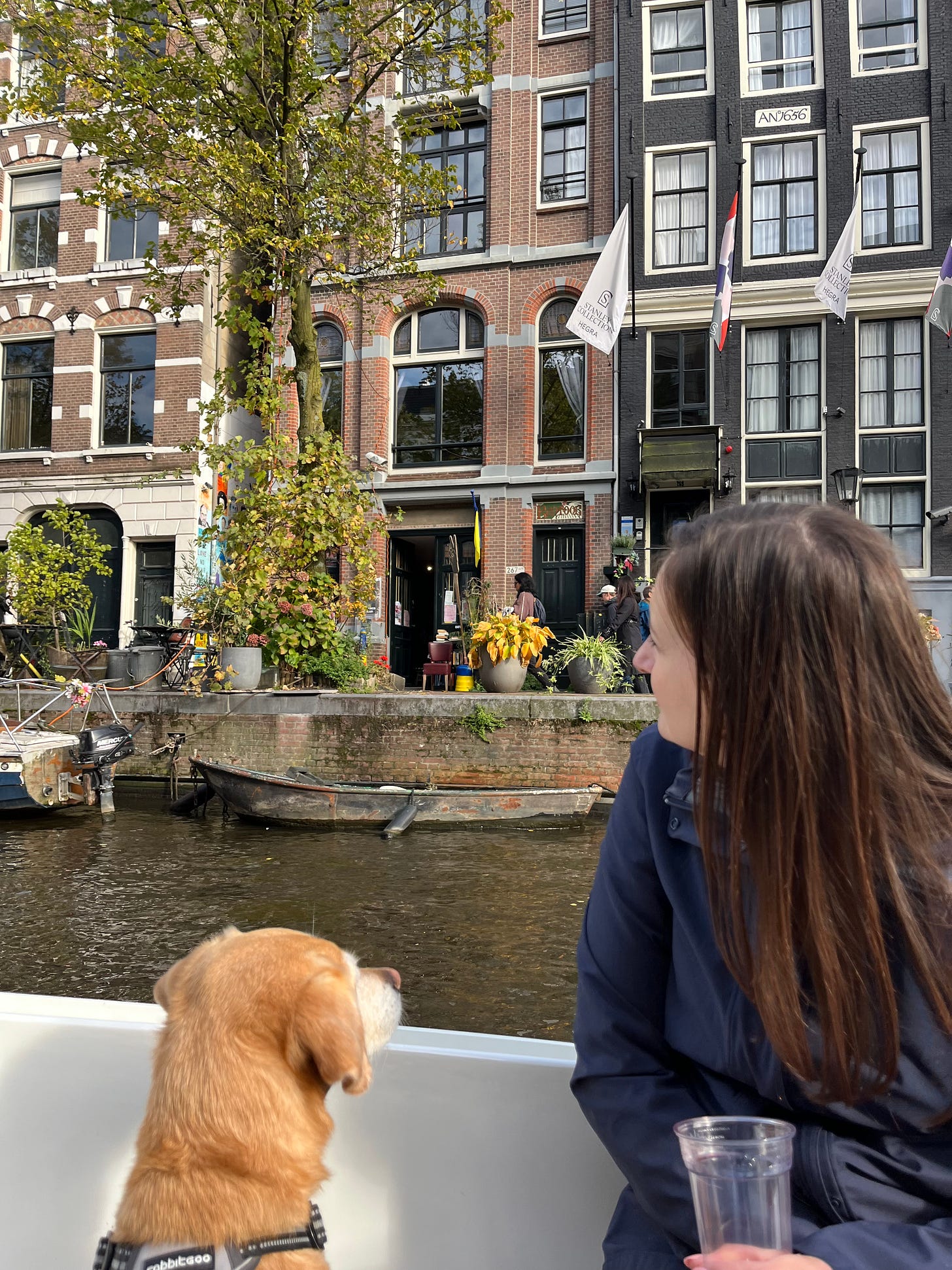 woman and dog in a boat on a canal in Amsterdam