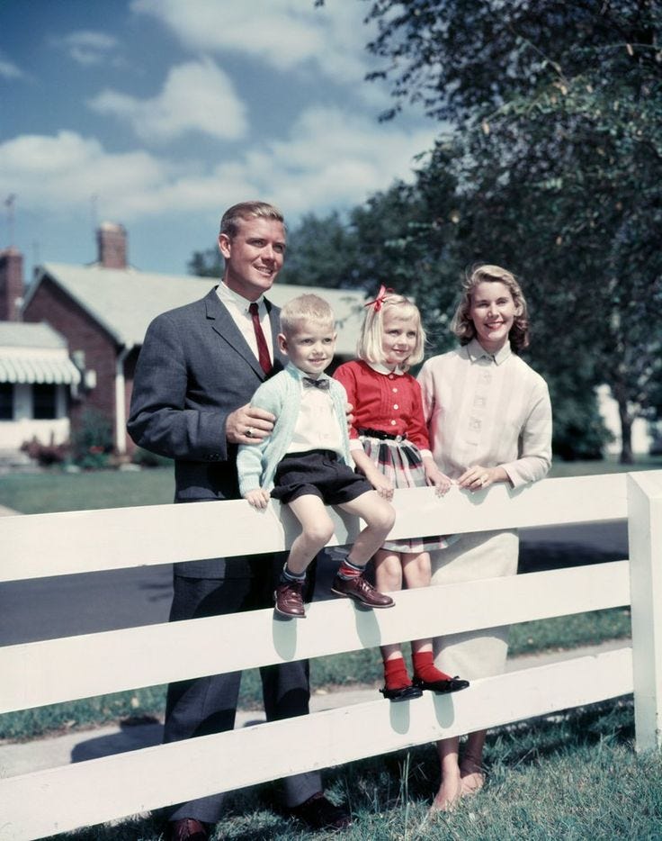 This may contain: a man and two children are sitting on a white fence with their father standing next to them