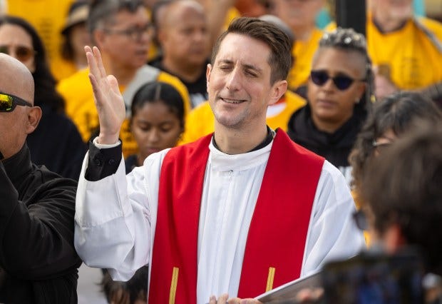 The Rev. David Inczauskis prays during a procession to the...