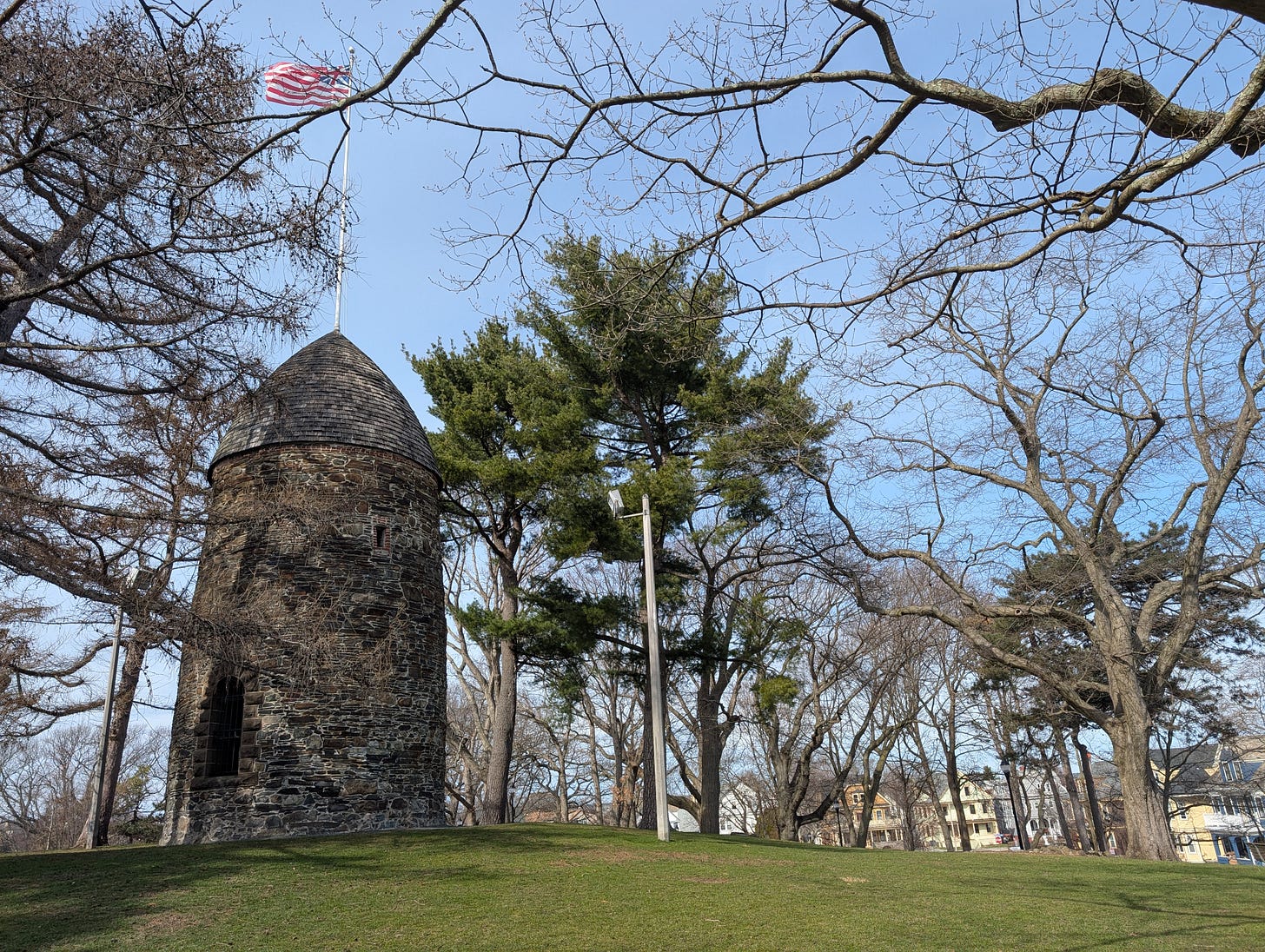 Photograph of a park with a large tower to the right
