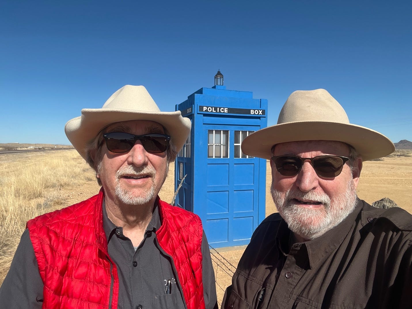 Two men wearing cowboy hats and sunglasses

Description automatically generated