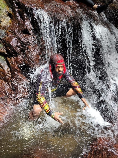 Leevan under a natural waterfall; with the Trinidad and Tobago flag; with his hiking group at the start of a hike and at the summit of a mountain; Leevan on a hospital bed, hospitalised with aplastic anaemia.