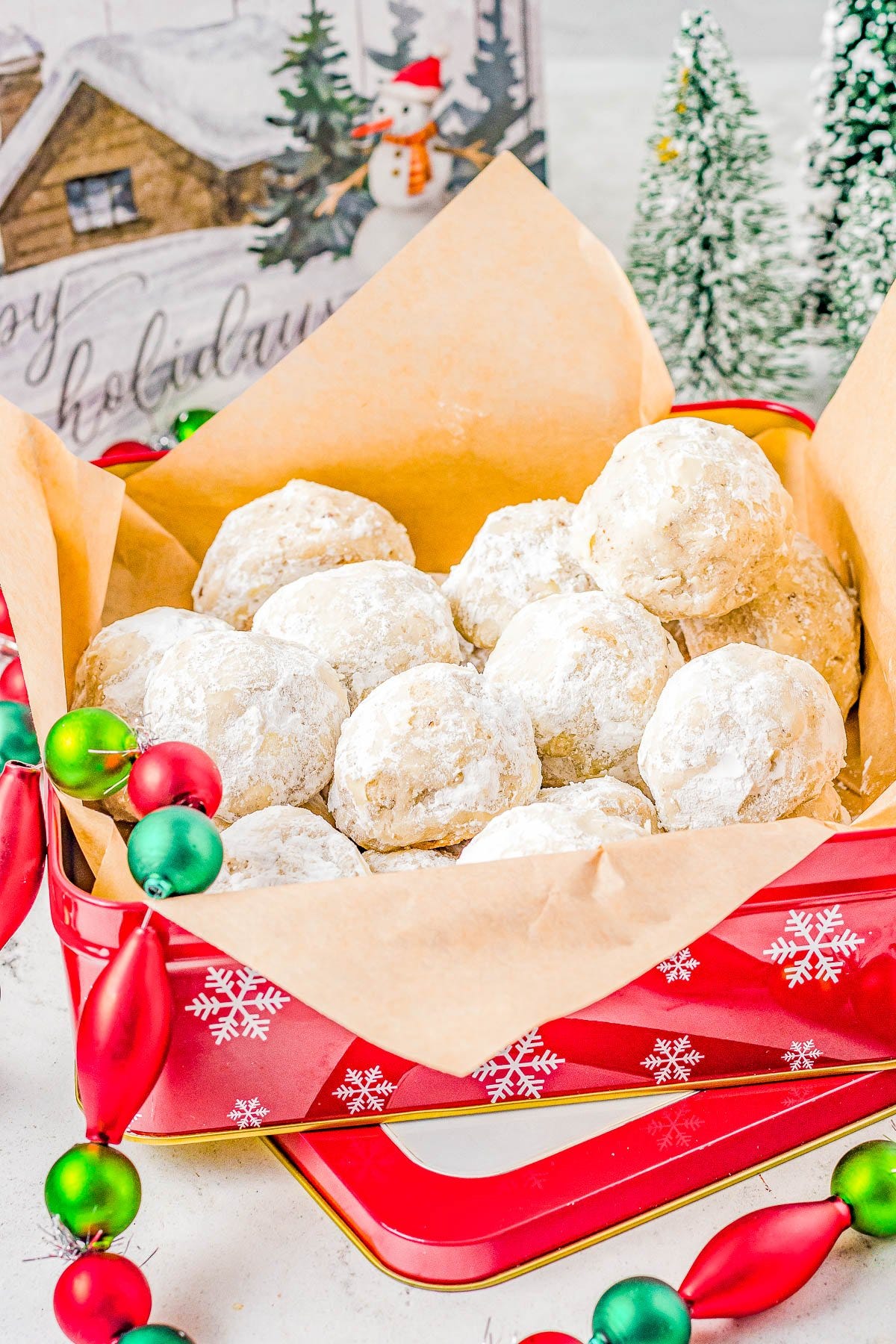 Snowball Cookies in a Christmas tin with brown wrapping paper. Snowball Cookies in a Christmas tin with brown wrapping paper.