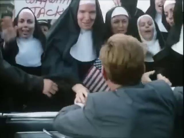 JFK in the motorcade, Jackie in the motorcade, cars in the motorcade, JFK shakes nuns' hands.