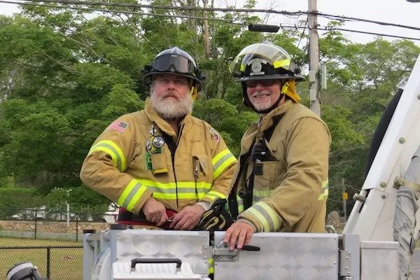 George Church & I, wearing firefighter gear, in the bucket of Tisbury 651 George Church & I, wearing firefighter gear, in the bucket of Tisbury 651