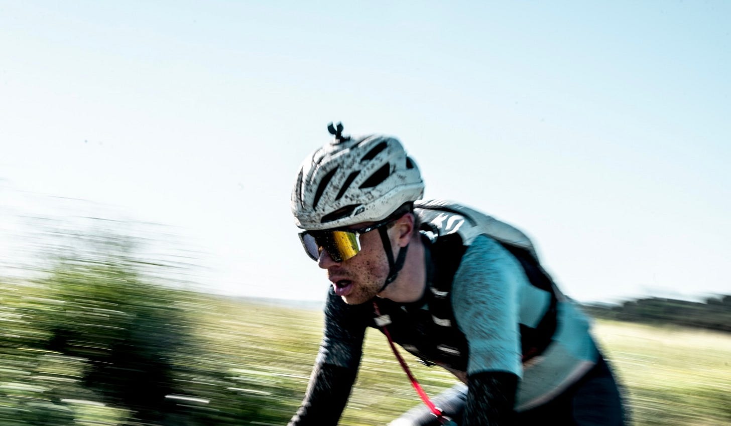 a rider's face covered in mud during the Traka 360 gravel race