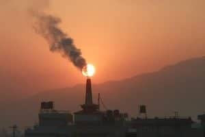 polluted skyline with smokestack in background