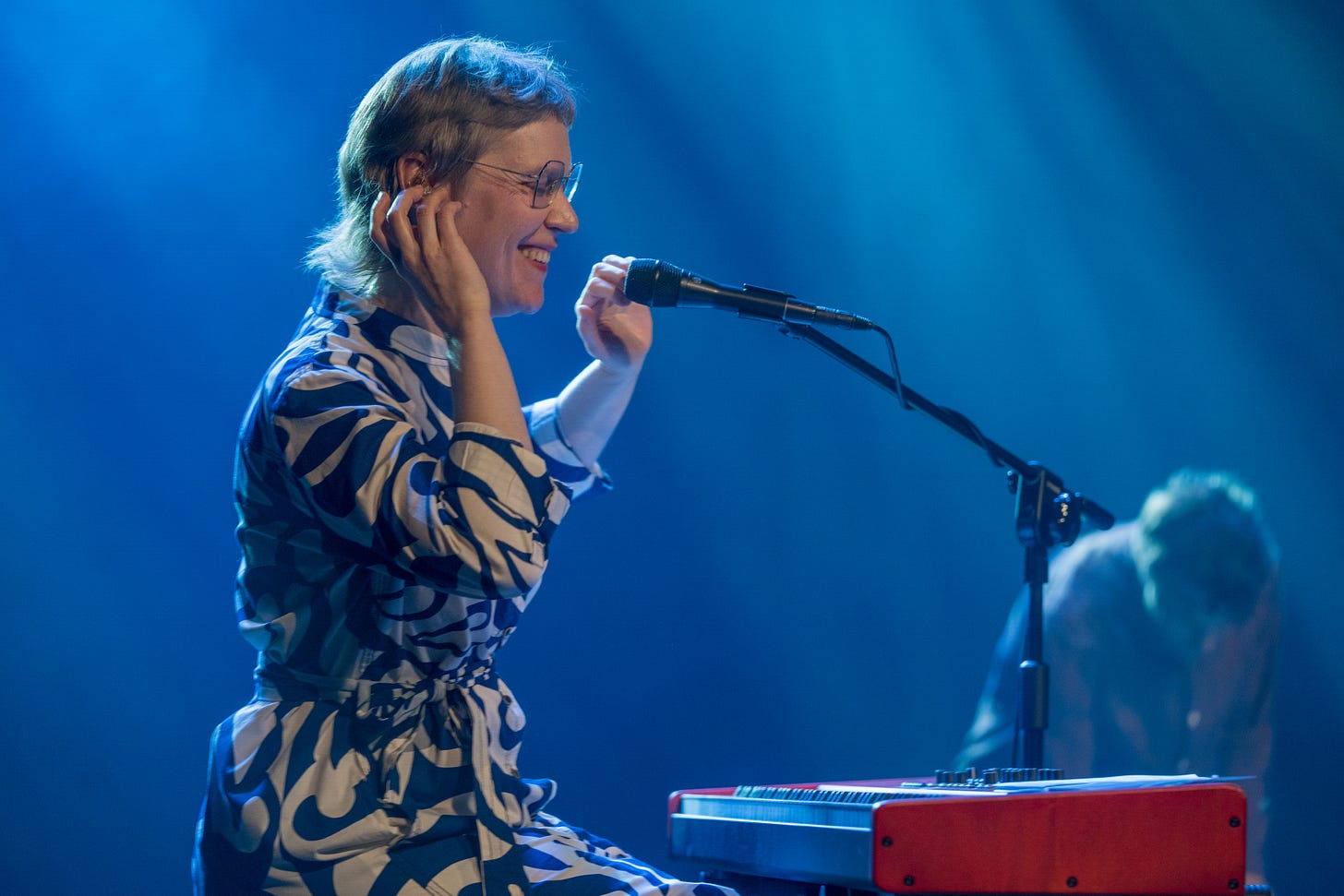 Gaba onstage, smiling over.a keayboard