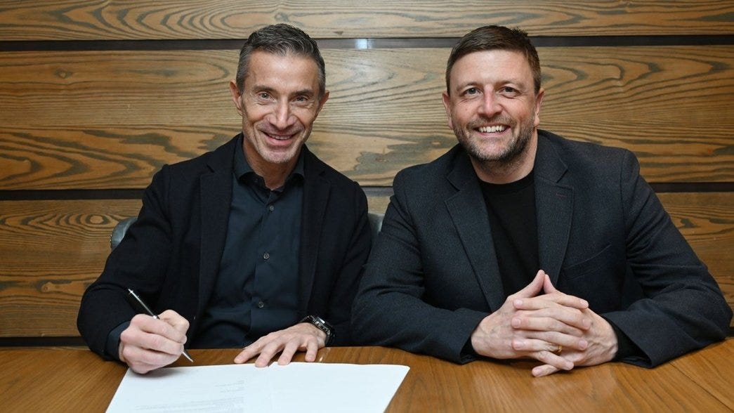 Andrea Berta signs contract alongside Richard Garlick Andrea Berta signs contract alongside Richard Garlick