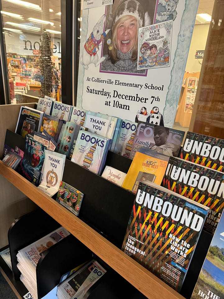 Two photos of the cover of MPL Unbound magazine, first in a tiered magazine rack at Novel bookstore and second laying in a stack on a store counter.
